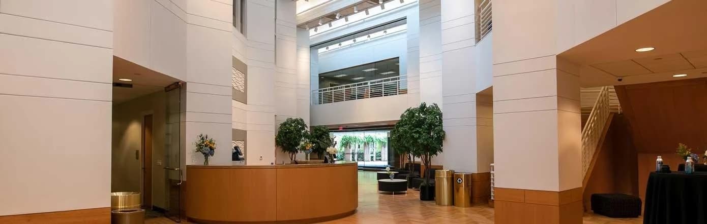 Inside the NCBC Galleria: a three-storey atrium with a reception desk and seating